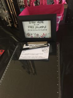 there is a sign on the table that says enter here and free jewelry in front of it