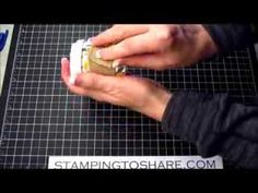 a person is using a small device to cut something out of paper on a cutting board