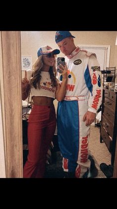 a man and woman dressed up in racing gear