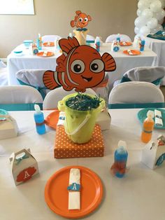 an orange and blue birthday party with clown fish decorations