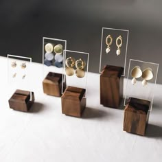 several wooden boxes with earrings on them