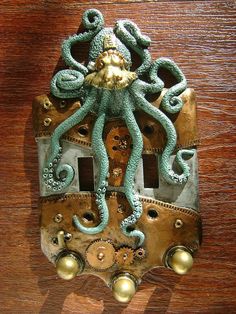 an octopus is attached to a light switch cover