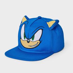 Complete your kid's cool outfit with this Sonic the Hedgehog Hat in blue for a fan favorite look. Made of 100% polyester, this hat features a back snap and adjustable strap for a customized fit. Plus, the 6-inch brim length provides ample shade during outdoor activities. Designed in blue with Sonic's face plus ear details, it's sure to be your kid's new go-to pick for sunny days. Fun Blue Snapback Hat With Flat Brim, Blue Trucker Hat For Fan Merchandise, Blue Fun Style Snapback Hat, Fun Blue Flat Bill Hat, Fun Blue Visor Baseball Cap, Fun Blue Flat Brim Baseball Cap, Adjustable Blue Cap Costume Hats And Headpieces, Blue Adjustable Cap-style Costume Hats, Fun Blue Snapback Baseball Cap