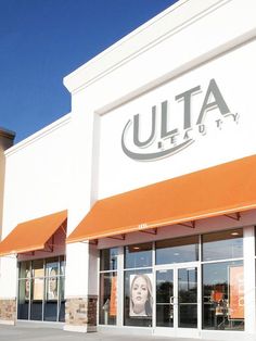 the facade of a beauty store with orange awnings and two women's heads