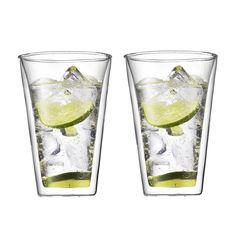 two glasses filled with ice and limeade sitting next to each other on a white surface