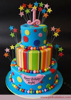 a colorful birthday cake with stars and balloons on it's top is the number one