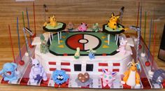 a birthday cake decorated with pokemon characters