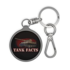 a metal keychain with an image of a tank on the front and back