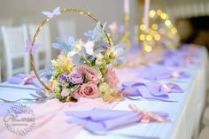 a table topped with a basket filled with pink and purple flowers on top of it