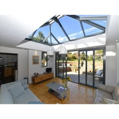 a living room with glass walls and wooden floors