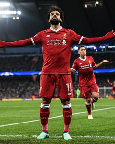 a soccer player with his arms outstretched on the field