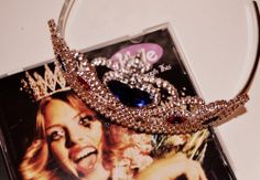 a tiara on top of a cd with a picture of a woman's face