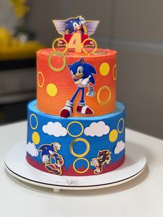 a three tiered cake decorated with sonic the hedgehog characters