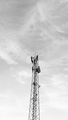 a black and white photo of a cell phone tower