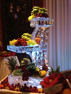 a platter filled with lots of fruit on top of a table