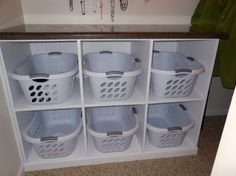 a white shelf filled with lots of laundry baskets