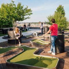 people are playing miniature golf on the deck