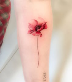 a single red flower on the left arm