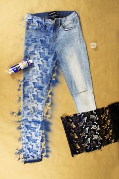 two pairs of blue jeans with lace on them and one pair of black brailles