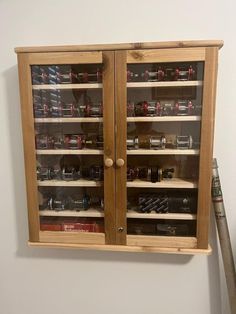 a wooden cabinet with glass doors and shelves