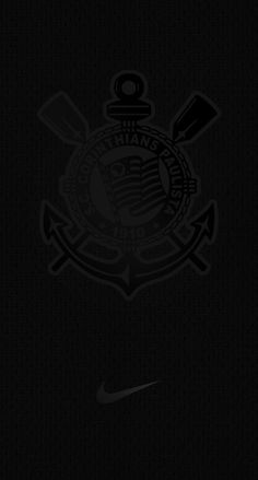 the back side of a black nike wallpaper with an emblem and two crossed swords