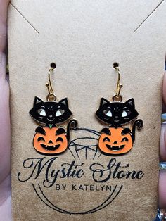 Add a spooky touch to any look with these ?jack-o-lantern style earrings! Crafted in gold plated metal and totally nickel free and hypoallergenic, these ?black cat earrings add the perfect Halloween ?touch to any style. Cute Black Pierced Jewelry, Cute Black Hypoallergenic Jewelry, Cute Black Dangle Jewelry, Spooky Hypoallergenic Jewelry For Halloween, Black Hypoallergenic Earrings For Halloween, Spooky Nickel Free Jewelry For Halloween, Black Drop Earrings For Halloween, Hypoallergenic Drop Earrings For Halloween, Halloween Hypoallergenic Metal Jewelry