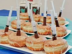 there are many donuts with icing on them sitting on the trays and ready to be eaten