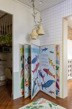 an open room divider with colorful fish on it