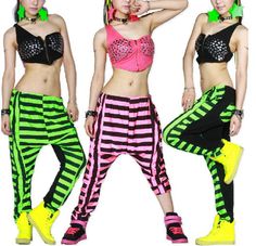 three young women wearing neon colored pants and bra tops