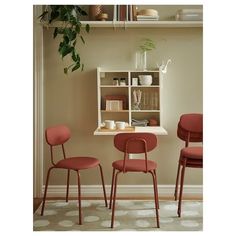 three red chairs are sitting in front of a shelf with books and cups on it