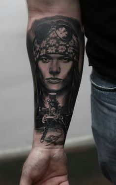 a man's arm with a tattoo on it that has an image of a woman