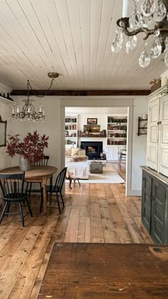 a dining room with wooden floors and white walls