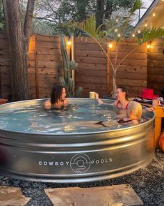 two people in a large hot tub with lights