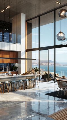 a large open kitchen and dining area overlooking the ocean