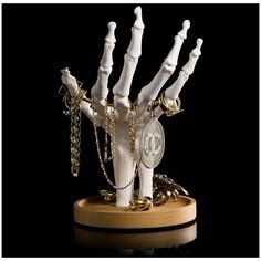 a fake hand with chains on it holding a coin