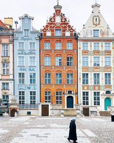 a person walking in front of some buildings