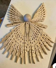 a wooden sculpture made to look like an angel's wings with numbers on it