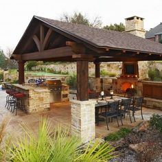 an outdoor kitchen and dining area is shown