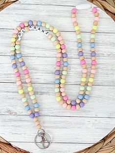 a multicolored beaded necklace with the word pray on it