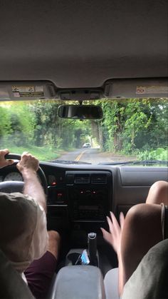 two people sitting in the driver's seat of a car