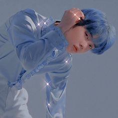 a man with blue hair is posing for the camera