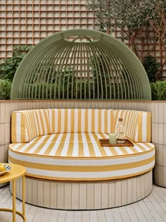 an outdoor seating area with yellow and white stripes