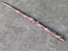 a long metal object sitting on top of a stone floor