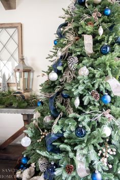 a decorated christmas tree with blue and silver ornaments