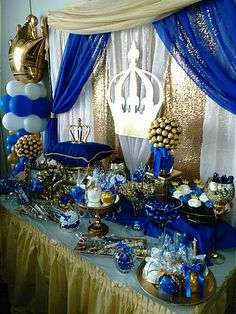 a table topped with lots of blue and gold decorations