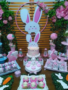 a table topped with lots of cakes and cupcakes