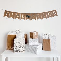 there are many bags on the table and one has a banner that says time flies