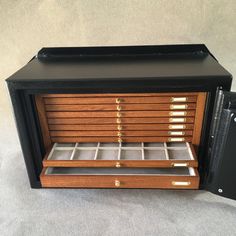 an old fashioned wooden jewelry box with drawers