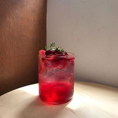 a red drink sitting on top of a table