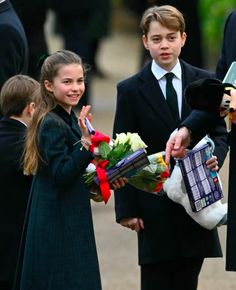 two children in school uniforms are holding flowers